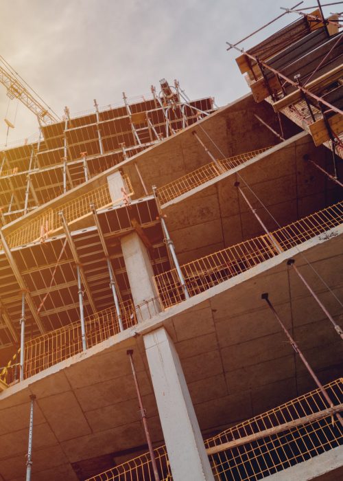 Building construction site with scaffolding, low angle view